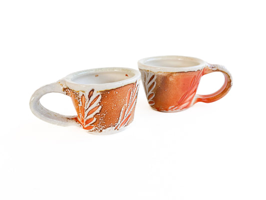 Brighten up your morning espresso with these unique cups! They have a handcarved leaf pattern around the sides.