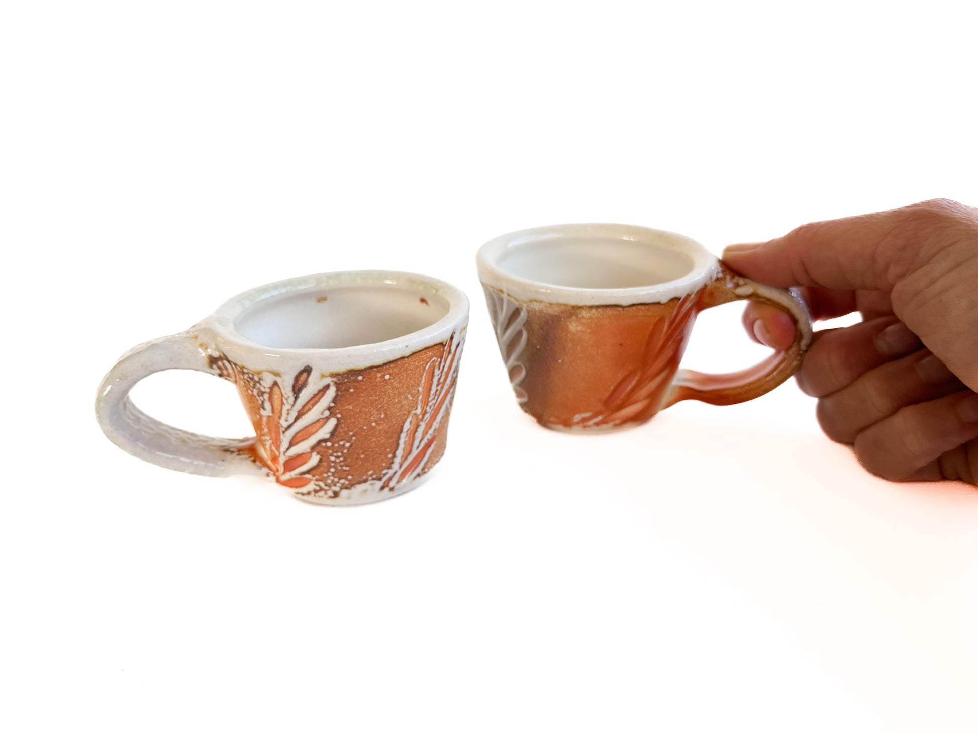 Brighten up your morning espresso with these unique cups! They have a handcarved leaf pattern around the sides.