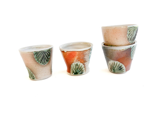 These small cups perfect size for water, or juice for kids. They would also make unique wine cups. They have a handcarved green leaf pattern around the sides.
