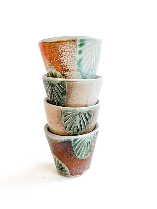 These small cups perfect size for water, or juice for kids. They would also make unique wine cups. They have a handcarved green leaf pattern around the sides.