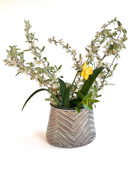 This beautiful oval flower vase has a carved leaf design with greem, purple, red and white mixed tones.