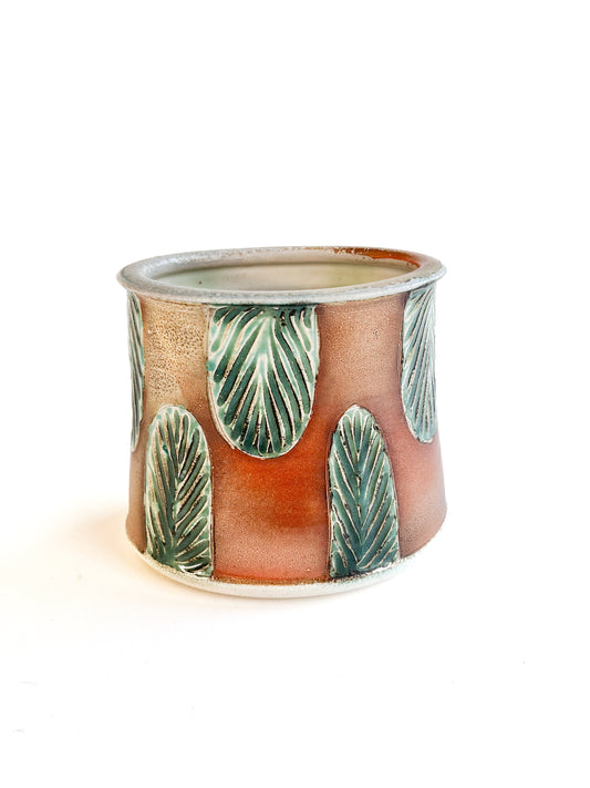 This beautiful oval flower vase has a green carved leaf design.