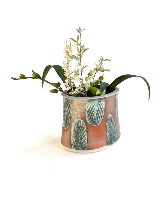 This beautiful oval flower vase has a green carved leaf design.