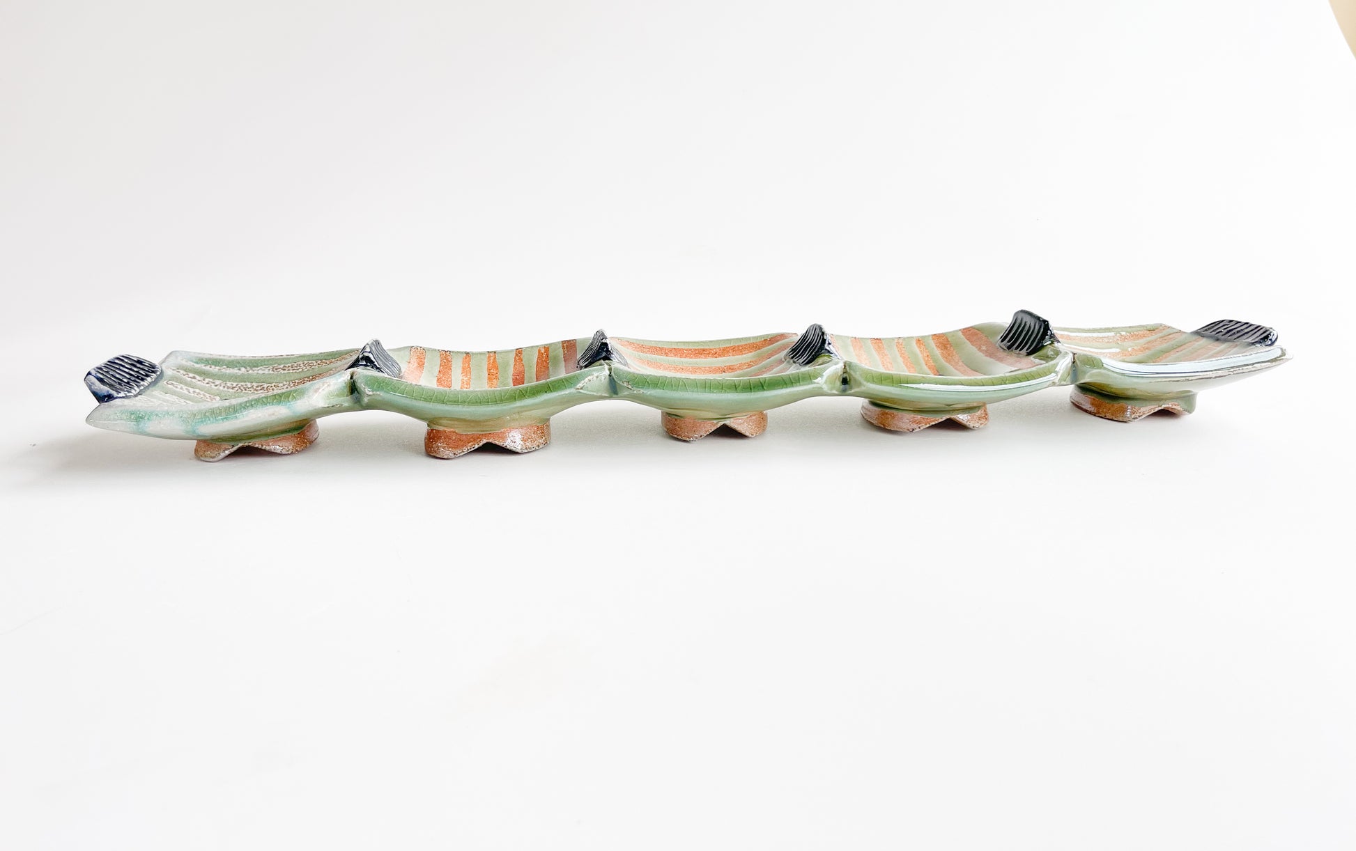 This unique green rectangle tray could be used for serving olives or cheeses, or used as table centerpiece.