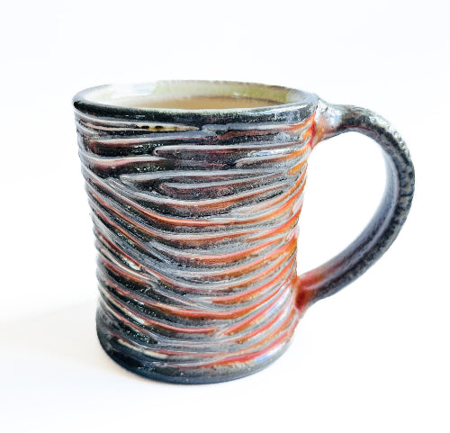 earth toned handmade pottery mug with handcarved texture