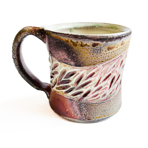 earth toned handmade pottery mug with handcarved texture