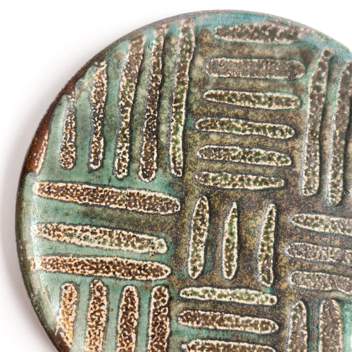 detail of a green patterned small plate