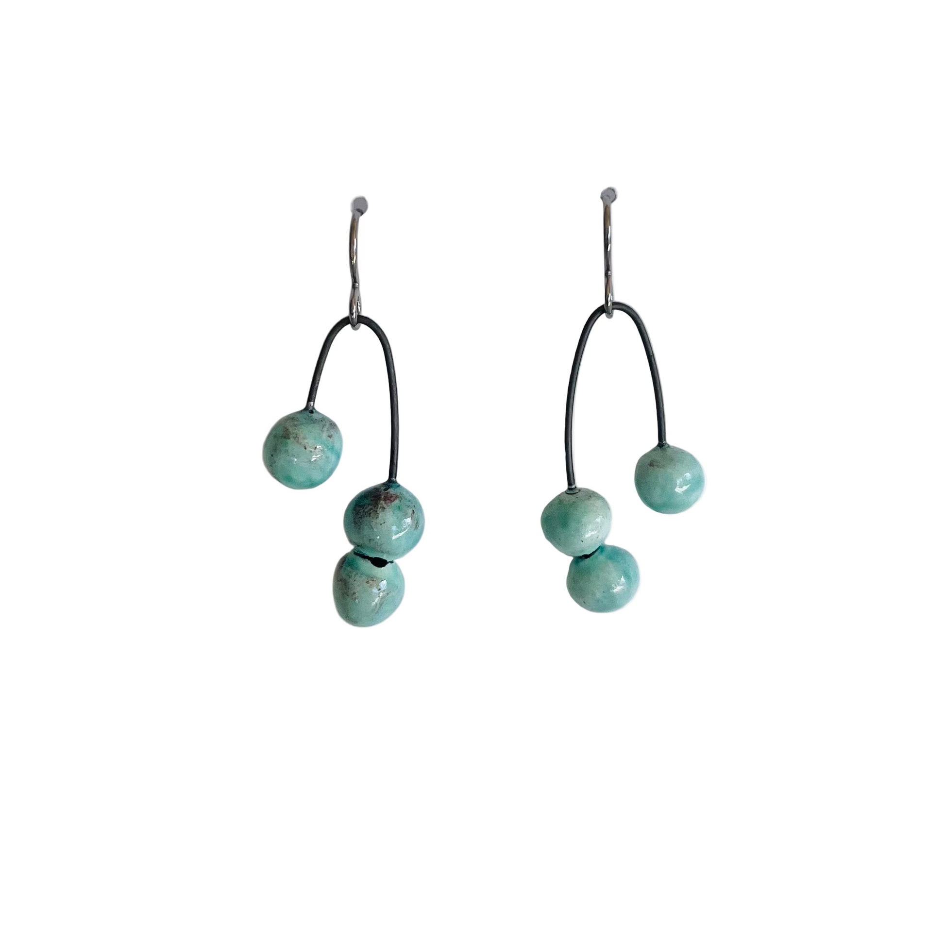 Pair of earrings with turquoise beads on a white background