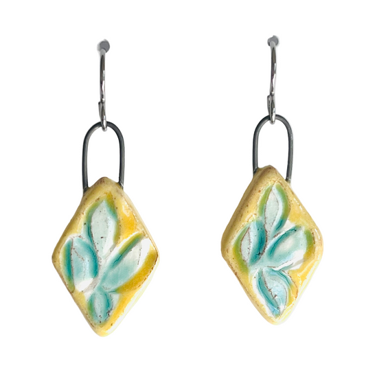 handmade yellow clay earrings with turquoise leaf pattern