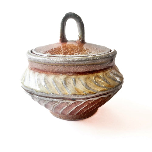 Handmade small round pottery jar with carved pattern