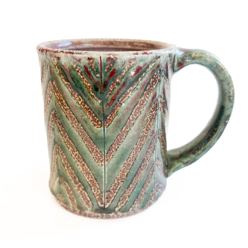 Ceramic mug with chevron pattern on a white background
