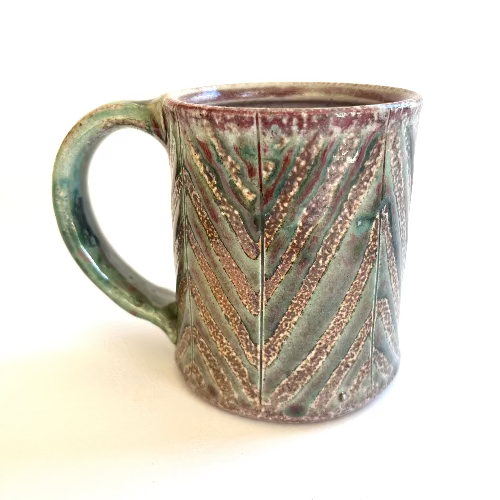 Ceramic mug with chevron pattern on a white background